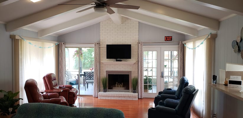Bright and welcoming living room with comfortable seating and a fireplace