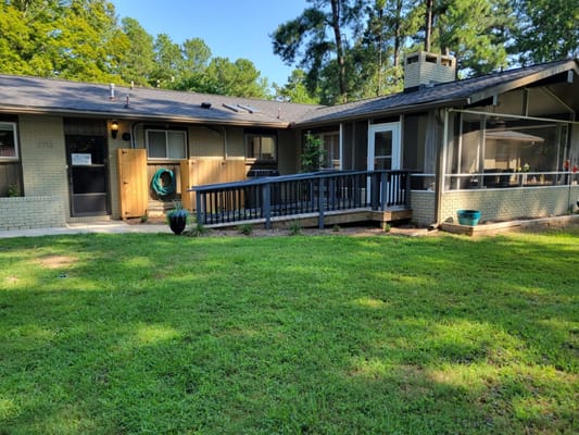Exterior view of Rockbridge Senior Home Living showing a porch and landscaping