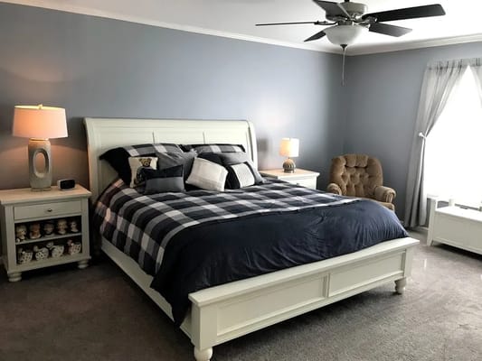 Cozy bedroom setup with a large bed and armchair