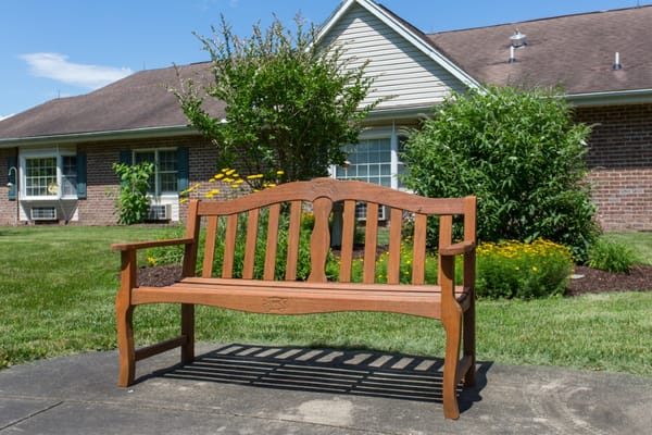 A wooden bench in a landscaped outdoor area