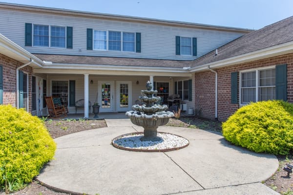 Courtyard with a fountain and landscaping in front of the building