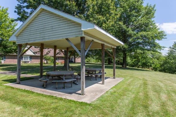 Outdoor shaded seating area with picnic tables