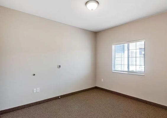 Empty room with a window and light fixture