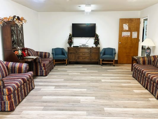 Inviting living room with striped sofas and a TV