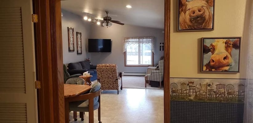 View of a cozy living room area with seating and decorative artwork.