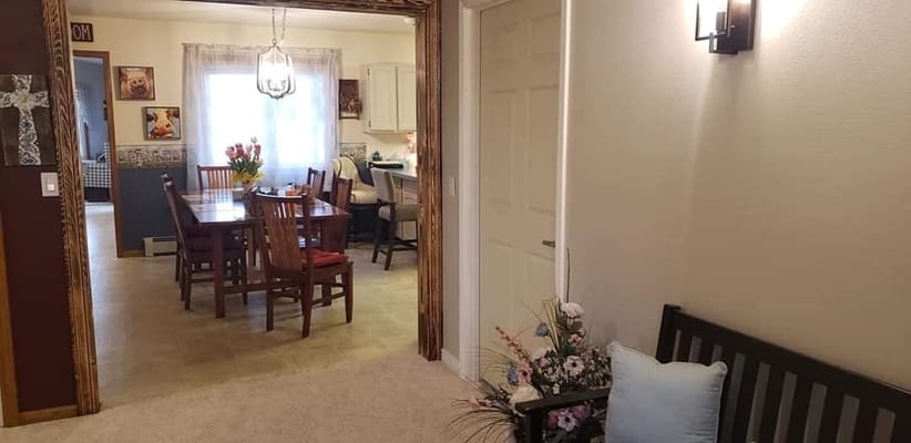 Entrance view leading to the dining area with a table and chairs.