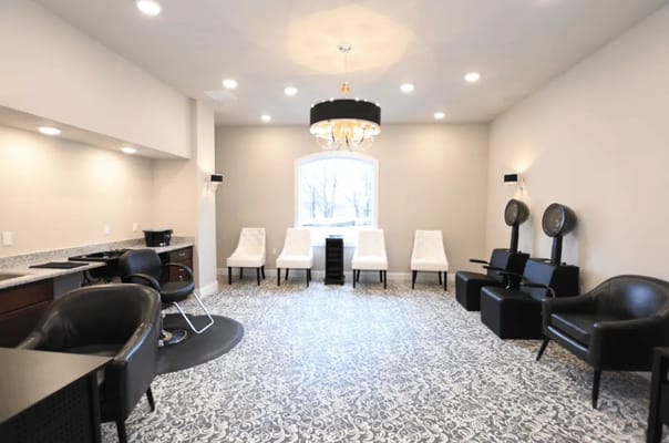 Interior view of the salon with stylish seating and a chandelier