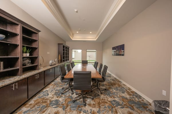 Modern conference room with a long table and seating