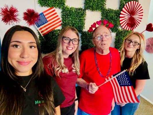 Residents and staff celebrating with flags and decorations
