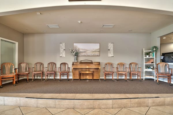 Common area with chairs and a piano