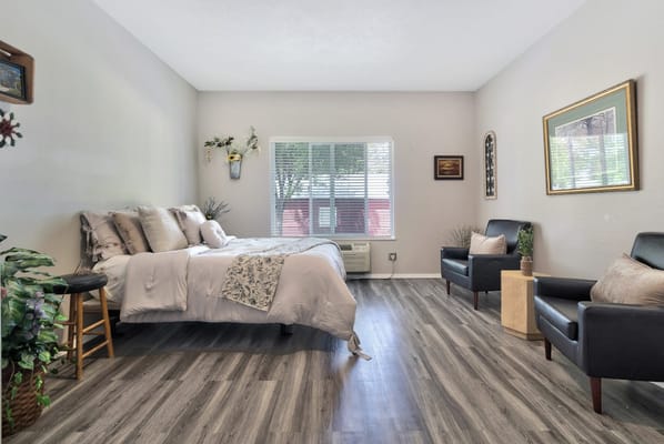 Cozy resident room with a bed and seating area