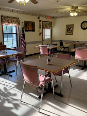 Brightly lit dining area with tables and chairs at Pine Mountain Veterans Home