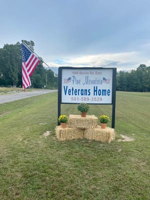 Sign for Pine Mountain Veterans Home with an American flag