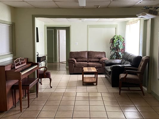 Cozy common area with seating and a piano