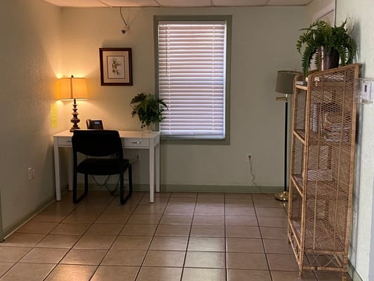 Interior corner of a facility with desk and lamp