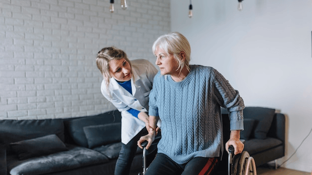 A caregiver assisting a resident in a bright interior space