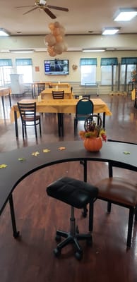 Interior of the dining room with yellow tables and autumn decor.