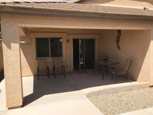 Outdoor patio area with chairs and a table