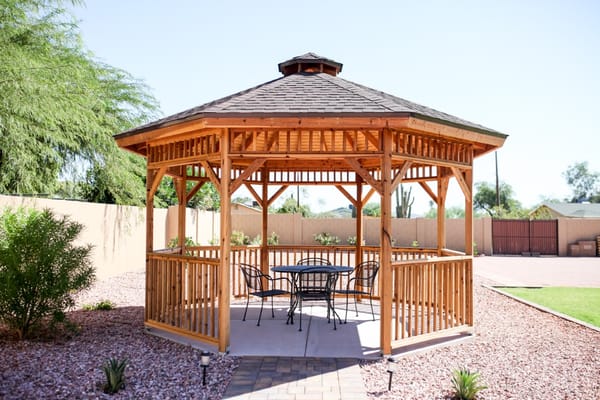 A wooden gazebo in an outdoor space