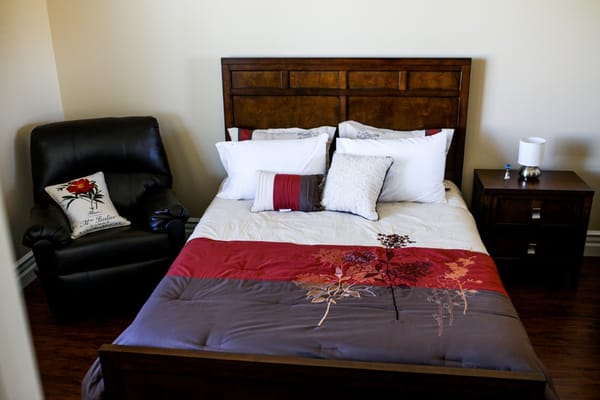 Cozy private resident room with a bed and armchair