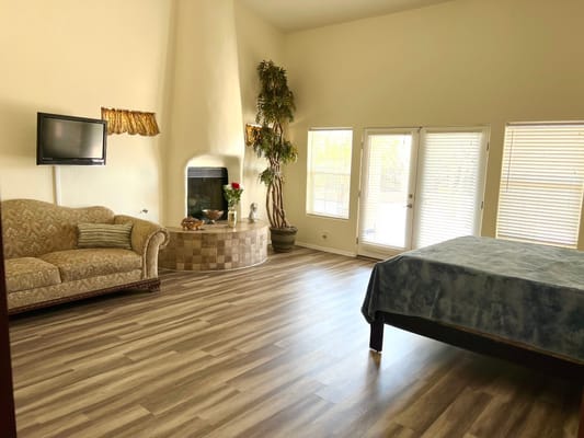 Spacious living room with a sofa, TV, and fireplace
