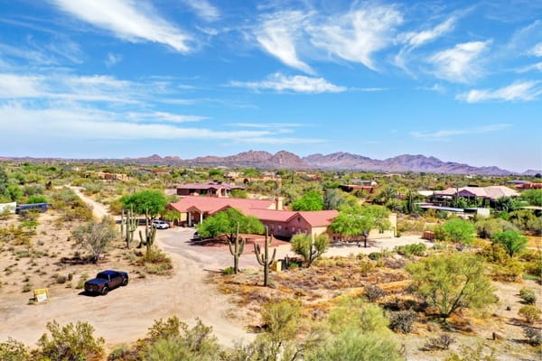 Aerial view of American Dream Home II surrounded by desert landscape