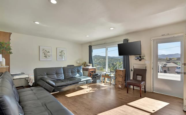 Bright living room with large windows and modern seating