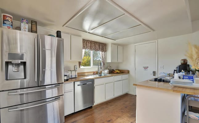 Modern kitchen with stainless steel appliances and natural light