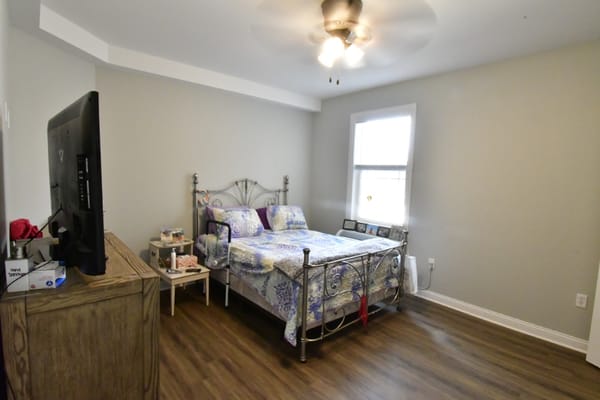Cozy resident bedroom with bed and television