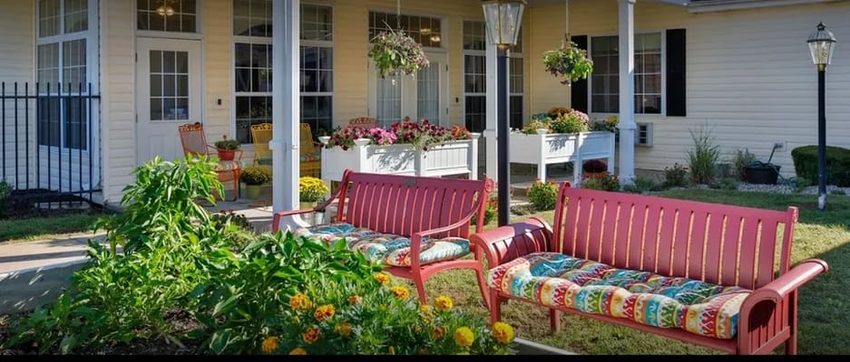 Outdoor seating area with colorful benches and flowers