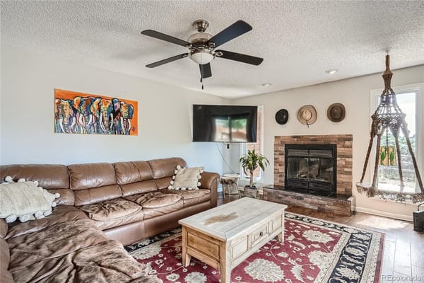 A cozy common area with a sofa and fireplace