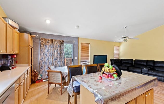 Bright kitchen and dining area with a table and couches