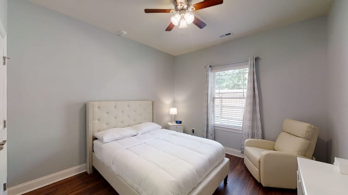 Cozy private room with a bed and chair