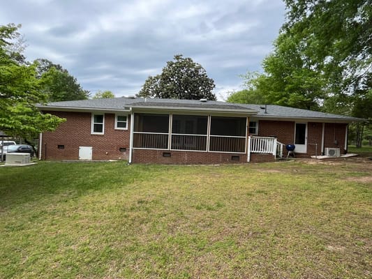 Exterior view of a senior care facility building with garden