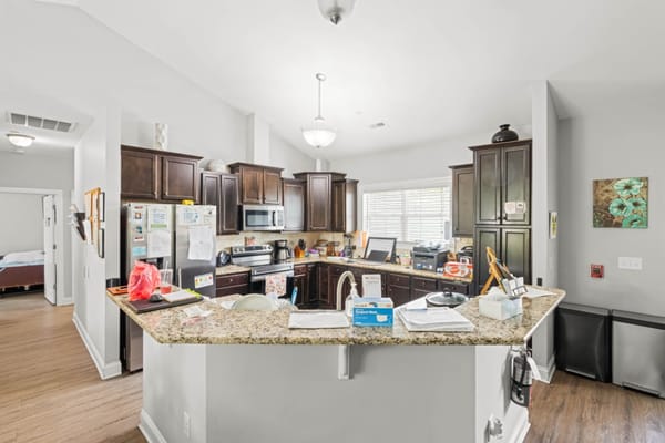 Modern kitchen with dark wood cabinets and granite countertops