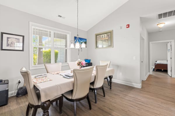 Cozy dining room with a table and chairs at Miss Bell's at Garner