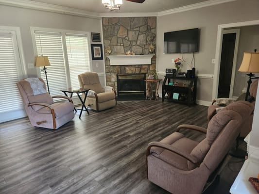 Spacious living room with recliners and a fireplace