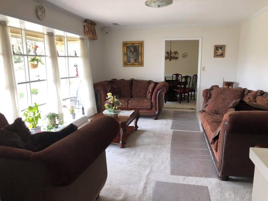 Cozy living room with brown sofas and floral decor