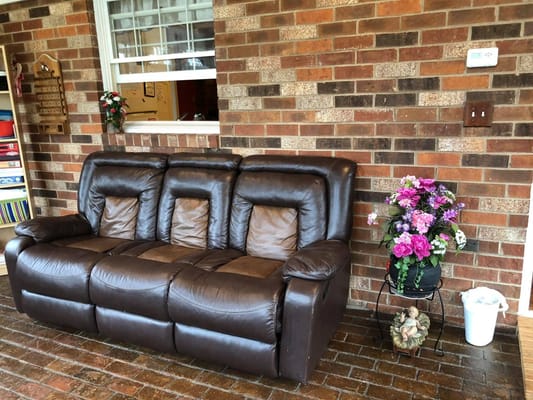 Brown couch with decorative flowers in a residential setting