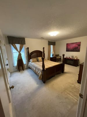 Well-appointed bedroom with a bed, two windows, and tasteful decor.