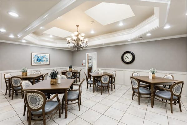 Dining area with multiple tables and a chandelier