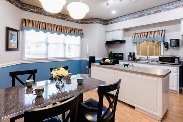 A well-lit kitchen area with dining table and decorations