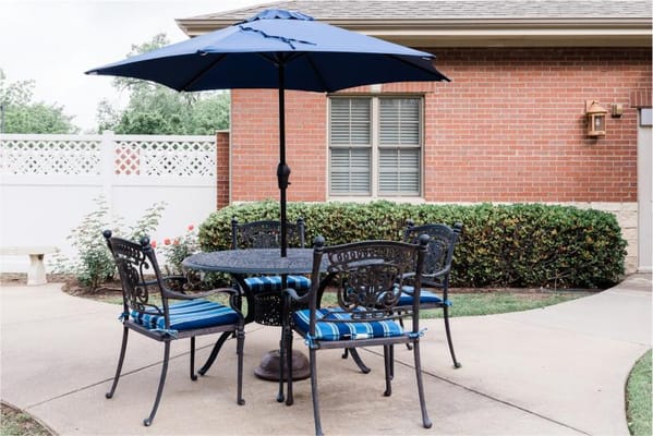 Outdoor seating area with a table and umbrella