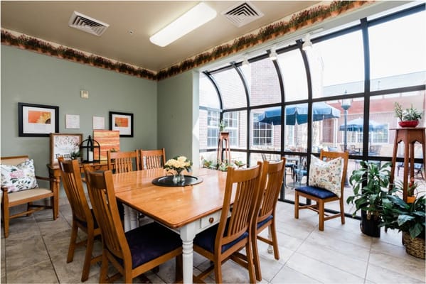 Interior dining area with large windows and plants