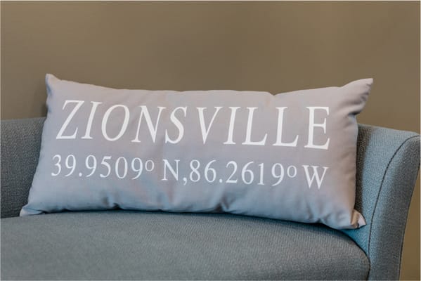 Decorative pillow with Zionsville coordinates