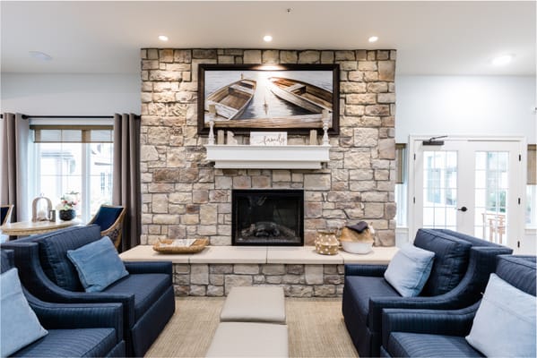 Comfortable living room with stone fireplace and seating