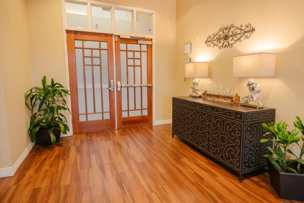 Interior lobby area with plants and lamps