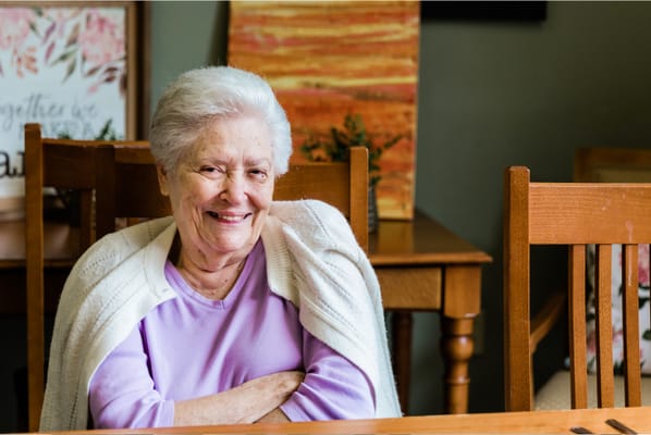 Smiling resident in an interior setting
