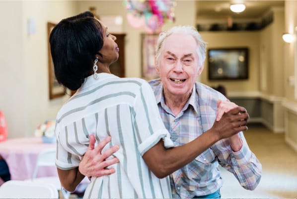 Residents dancing joyfully in a common area
