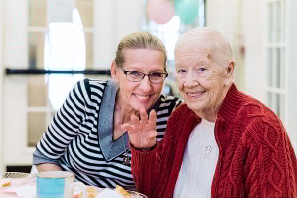 Residents enjoying a meal and smiling together
